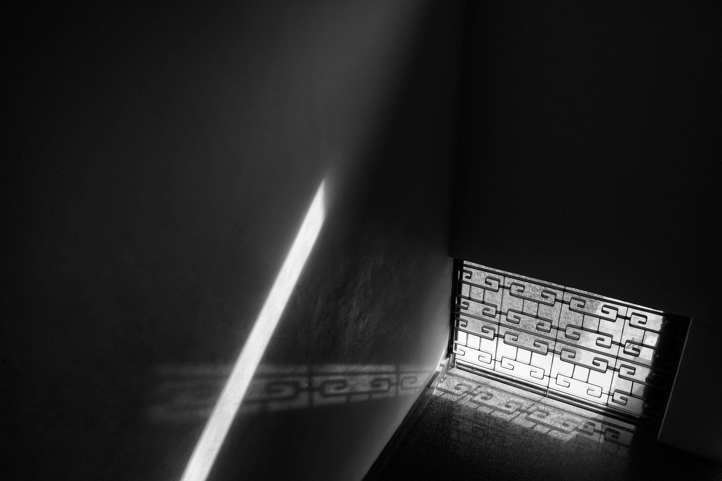 A single shaft of daylight crossing a dark room